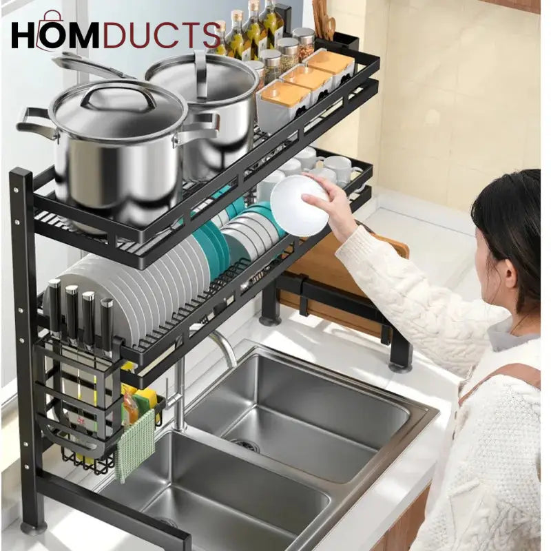 Angled view of a two-tier dish rack holding bowls, plates and cookware above a sink