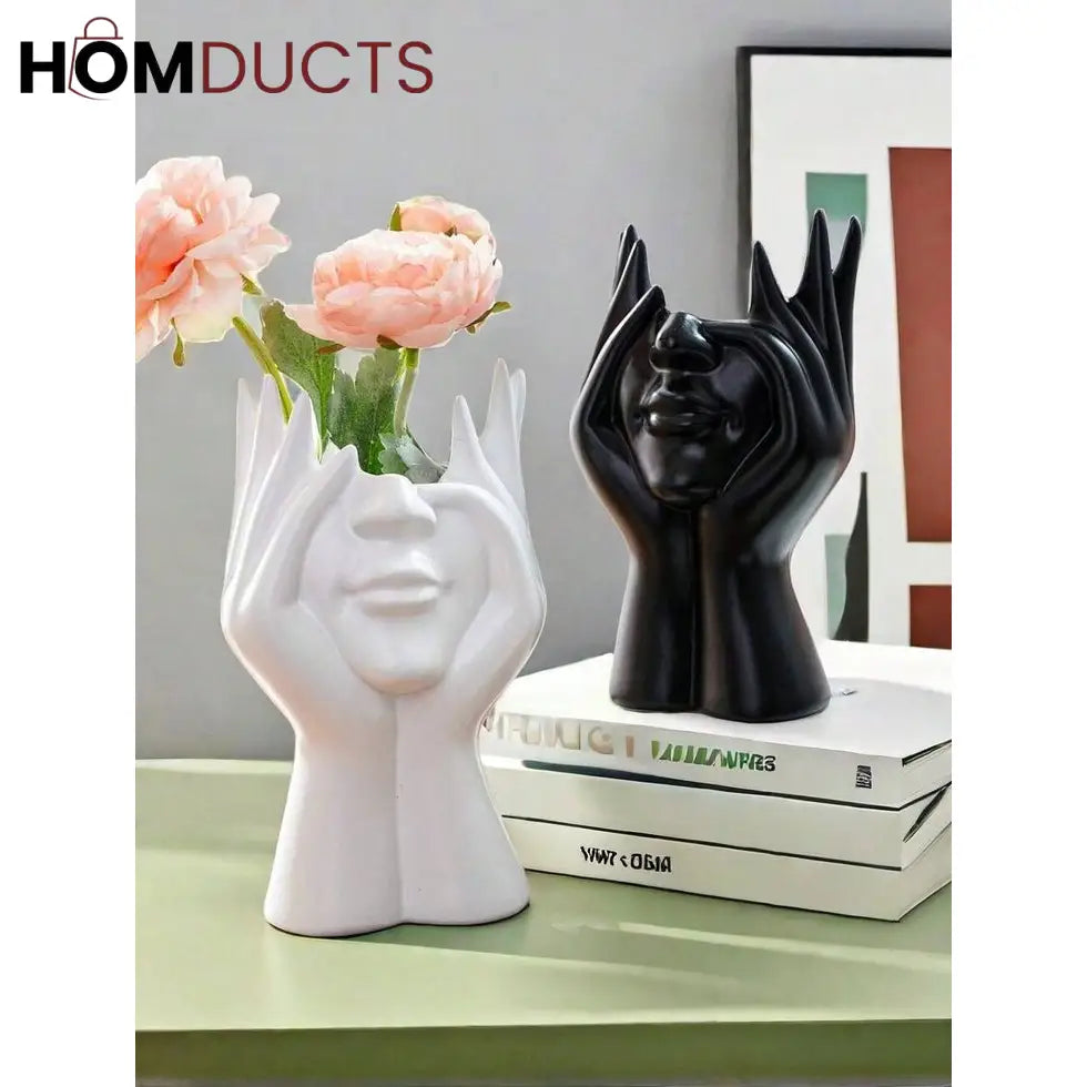 White and black face vases arranged on decorative books