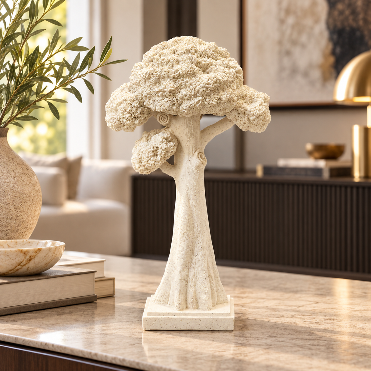 Tall cream sculptural tree ornament on a modern console