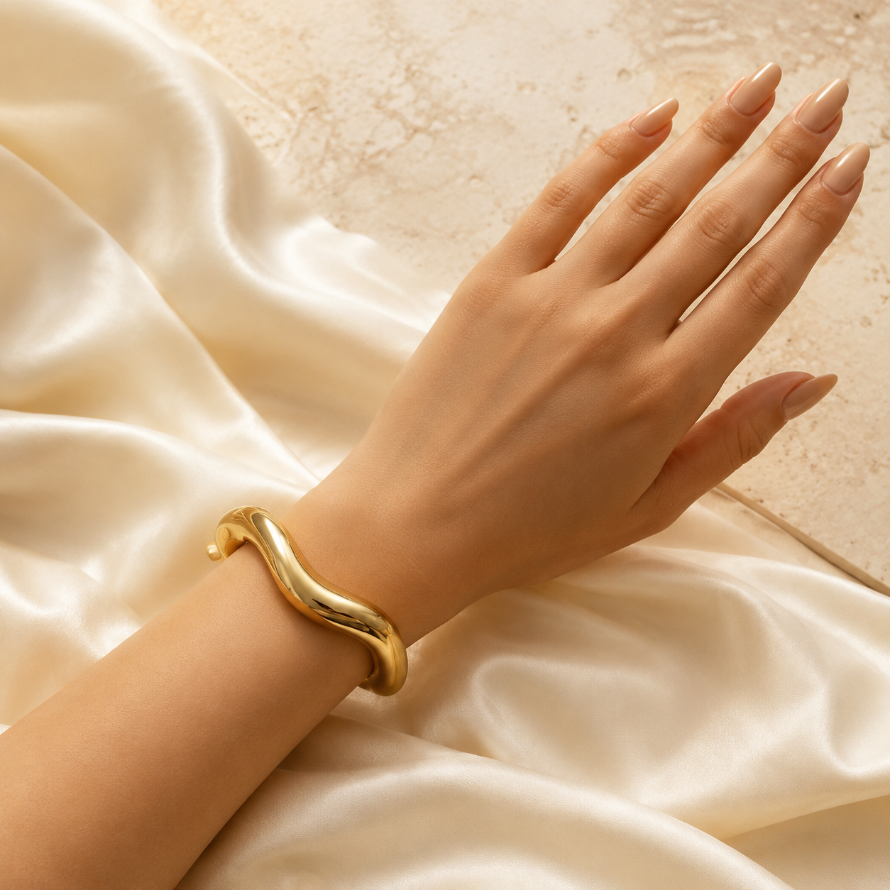 Luxury Gold Flowing Wave Cuff Bracelet correctly worn around an elegant feminine wrist