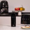 Black SMEG water bottle on a kitchen counter