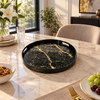 Round black marble-look serving tray with gold veining