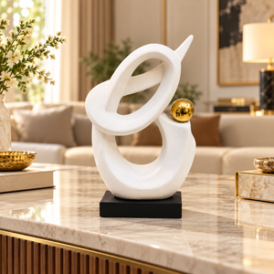 White infinity loop ceramic sculpture with gold sphere and black base