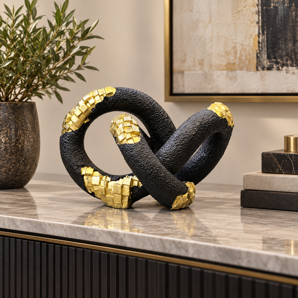 Black and gold interlocking loop abstract sculpture