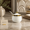 White and gold ceramic condiment jar with spoon