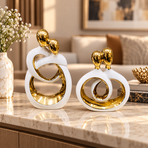 White and gold intertwined couple ceramic sculpture set in a styled interior