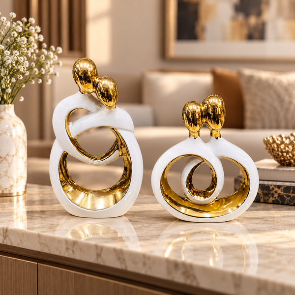 White and gold intertwined couple ceramic sculpture set in a styled interior