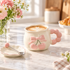 Cherry bow ceramic mug with cappuccino and spoon