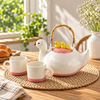 Duck-shaped ceramic teapot and two cups on breakfast table