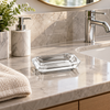Clear acrylic rectangular soap dish on a luxury bathroom vanity