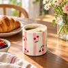 Cherry coffee cup with fixed lid in balcony setting