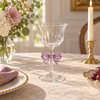 Clear stemmed glass with flared rim and purple bow