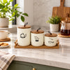 Three-piece floral ceramic storage jar set with wood lids and tray