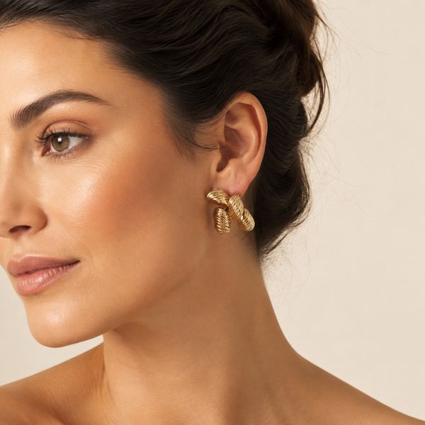 Luxury Gold Ribbed Four-Petal Stainless Steel Stud Earrings worn by a female model