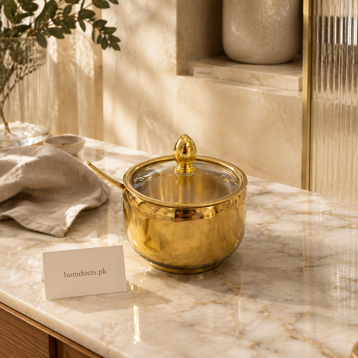 Golden condiment jar with glass lid and spoon