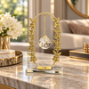 Gold oval floral frame with hanging crystal ball
