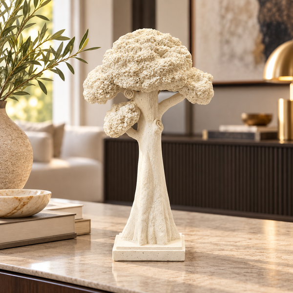 Tall cream sculptural tree ornament on a modern console