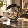 Black and gold couple under tree sculpture