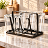 Bronze metal stand holding glasses upside down