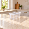 One clear rectangular refrigerator storage box with lid and end handle on a kitchen counter