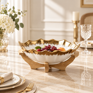 Gold scalloped ceramic fruit bowl with wooden stand
