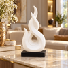 White intertwined flame abstract ceramic sculpture on black base