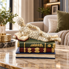 Ivory reclining reader on books sculpture