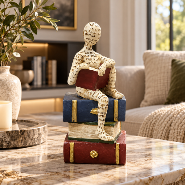 Ivory seated reader holding a closed book sculpture