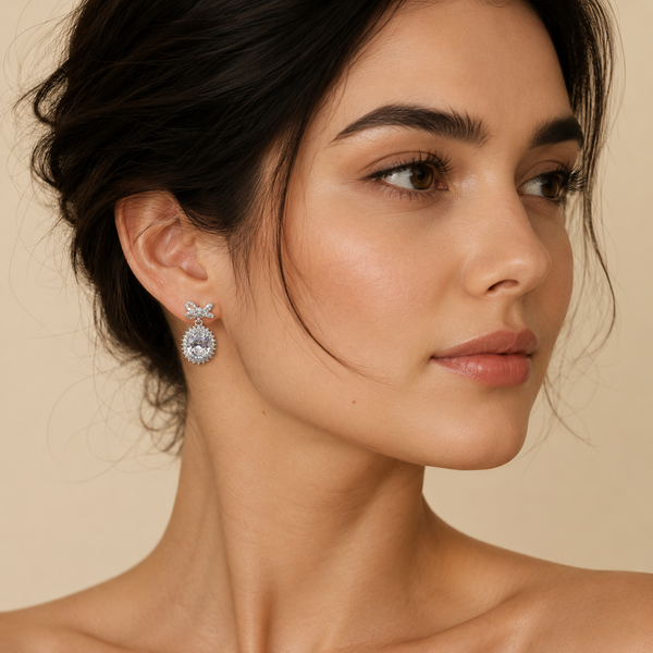 Luxury clear crystal bow oval crystal drop earrings worn by a female model