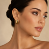 Luxury Gold Oval Dome Stainless Steel Stud Earrings worn by a female model