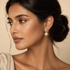 Luxury textured pearl drop earrings worn by a female model