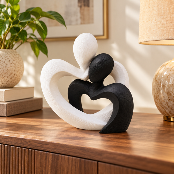 Modern black and white embracing couple heart sculpture