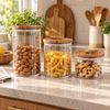 Round acrylic pantry jars with wooden lids in three sizes