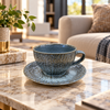 Blue grey ceramic cup and saucer with gold bark texture